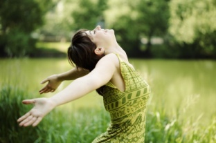 Girl throwing back her head and hands in joy