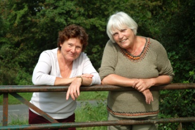 Women leaning on fence