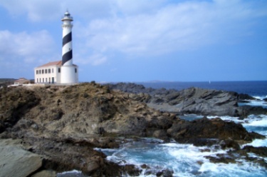Lighthouse surrounded by water and rocks