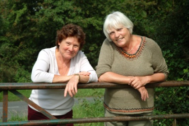 Women leaning on fence Women leaning on fence